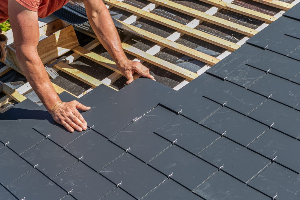Roofer adding slates to home in leeds